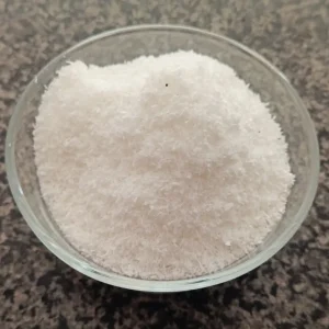 Desiccated coconut shreds (Nariyal Burada) in a glass bowl — ناریل کا برادہ