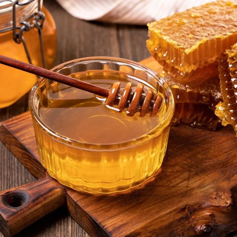 Natural honey with honeycomb and honey dipper for Awaisia Pansar