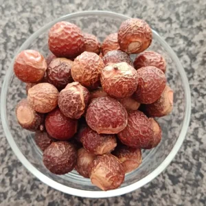 Whole dried Reetha soapnuts in a glass bowl at Awaisia Pansar — ریٹھا